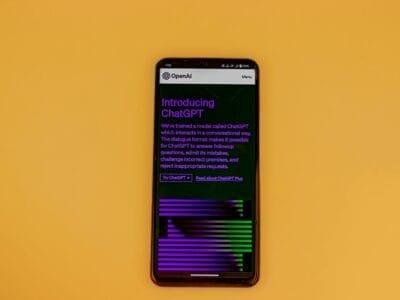 Smartphone displaying ChatGPT interface on a vibrant background, showcasing AI technology.