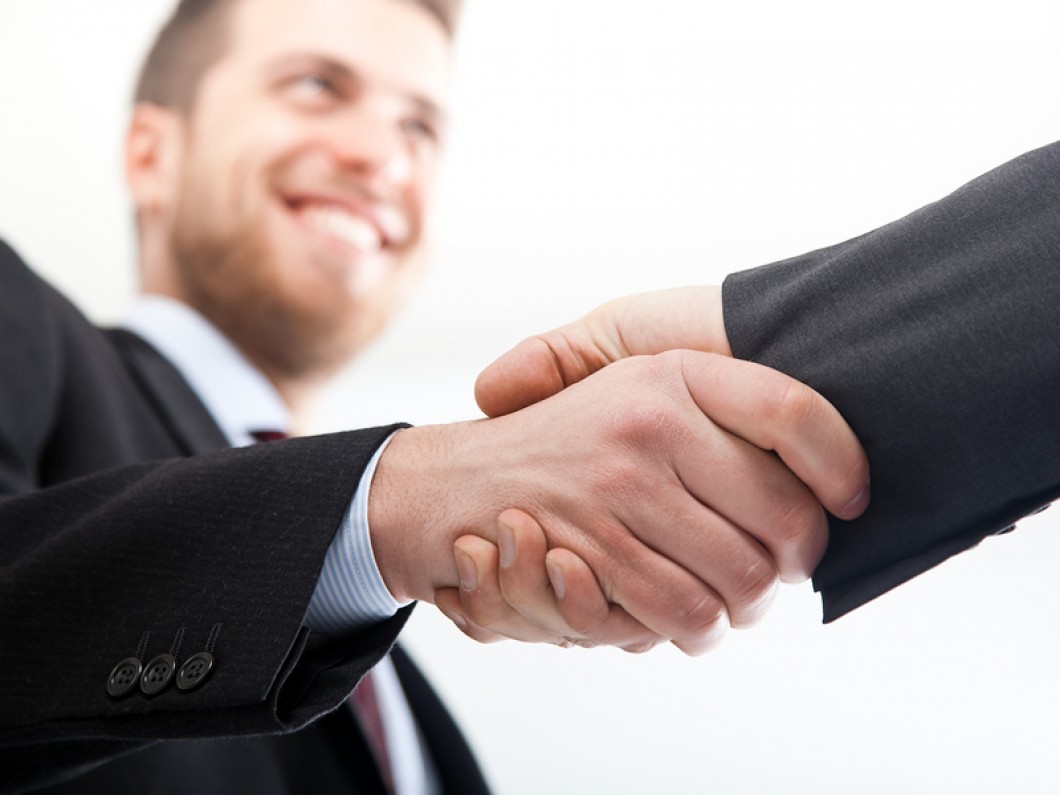 Two businessman shaking hands Straipsniai.lt
