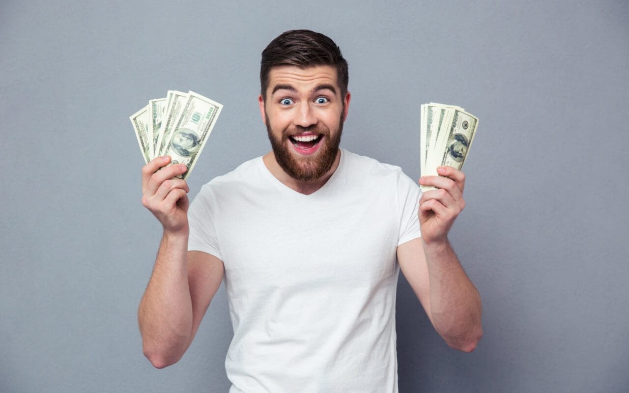Cheerful Man Holding Dollar Bills