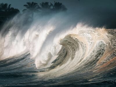 Captivating image of massive ocean waves breaking on the shore, creating a dramatic scene.