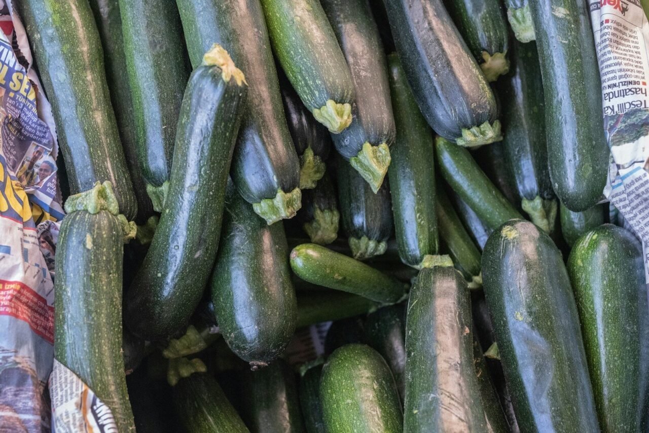 A pile of cucumbers sitting next to each other