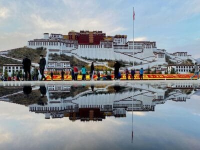 people walking on dock near white and brown building during daytime