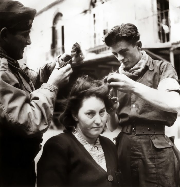 A French woman has her head shaved by civilians as a penalty for having consorted with German troops 1944 6 Straipsniai.lt