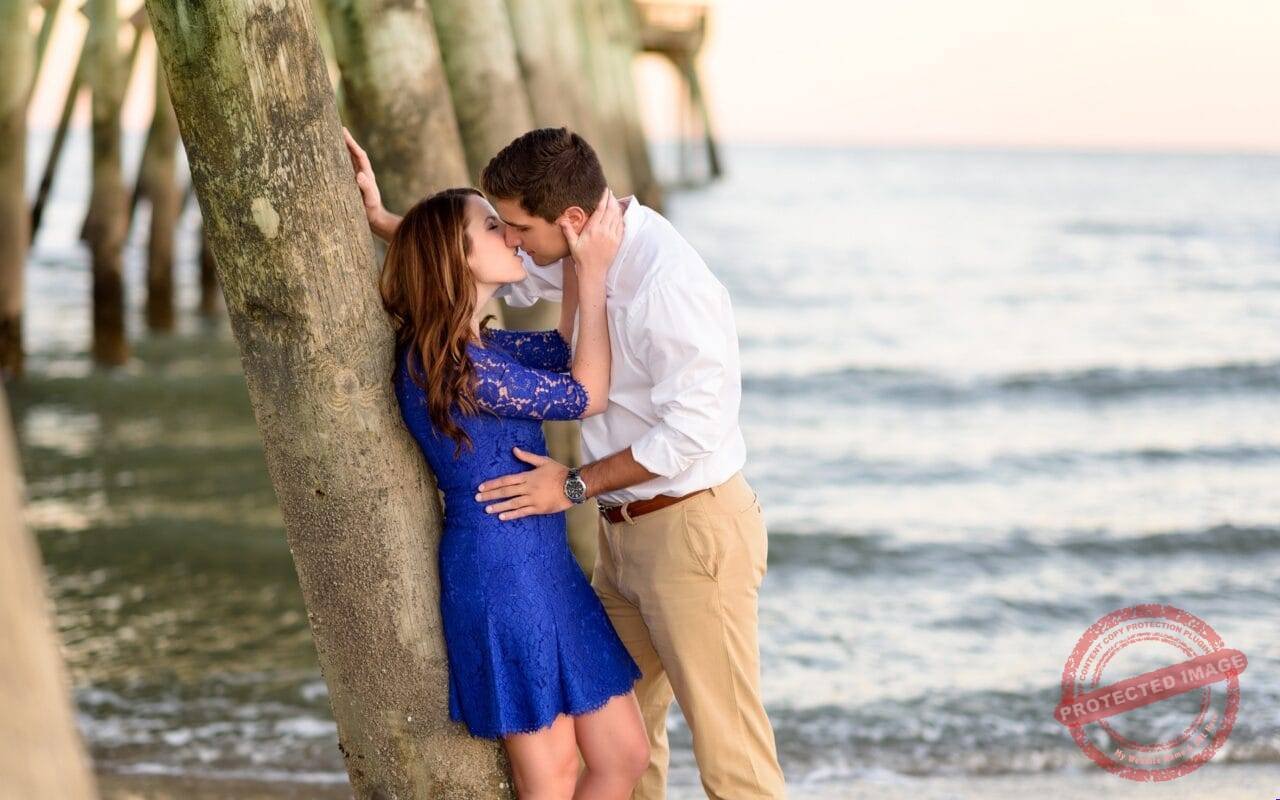 Couple kissing moods at beach under tree