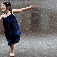 Cute girl in rain enjoying Straipsniai.lt