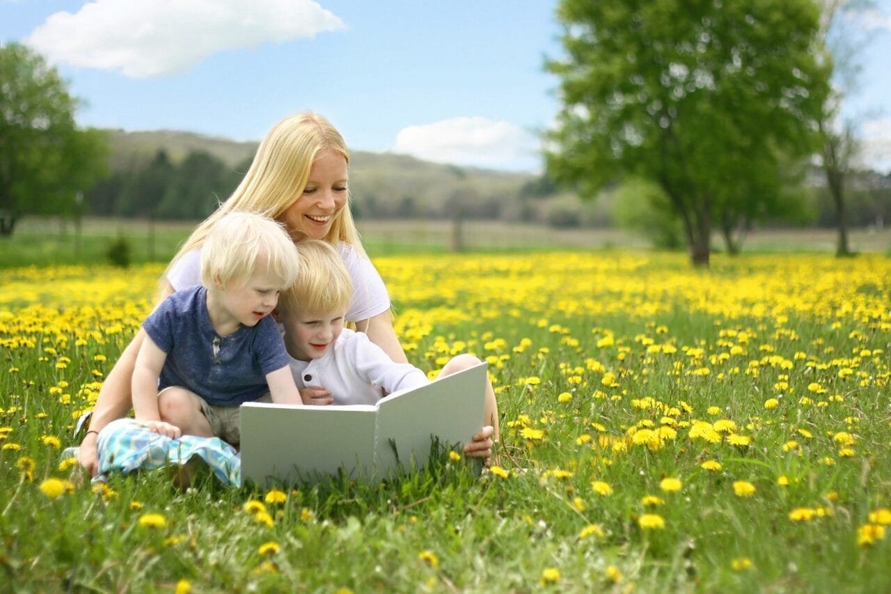 Cute kids read book in garden