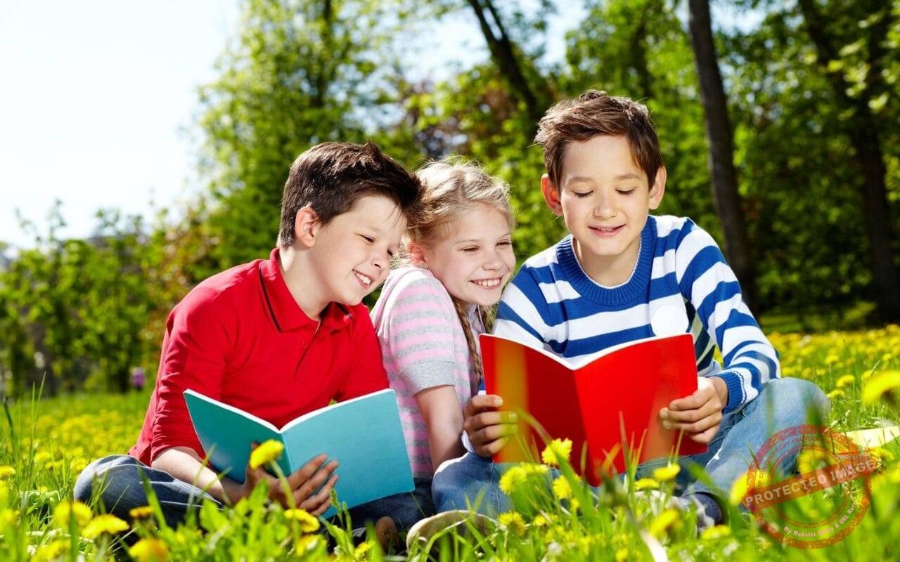 Cute kids reading in garden very happy