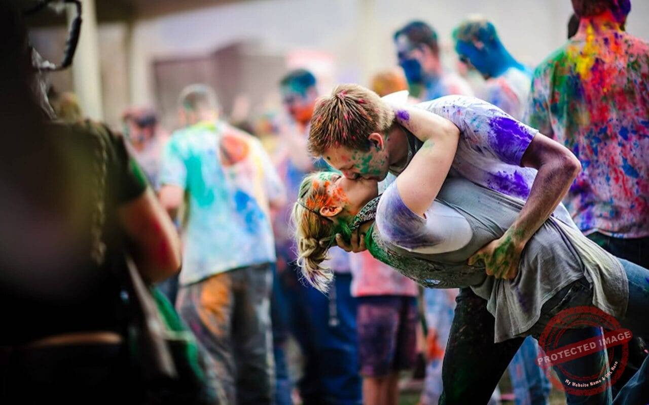 Romantic couple crazy kisses and hugs in holi festival