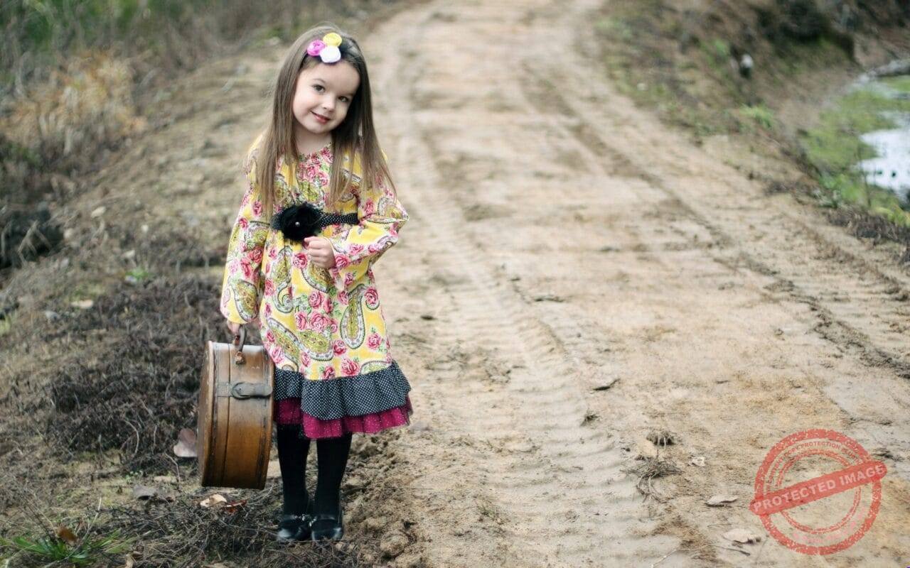 Stylish little cute girl with suitcase