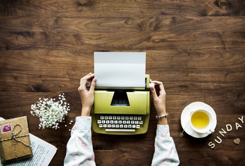 aerial-view-woman-using-retro-typewriter-hobby-sunday-leisure-concept_53876-24823