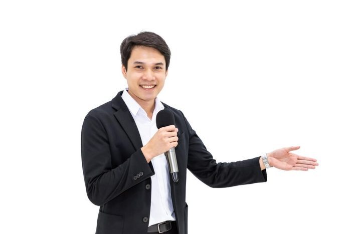 attractive-man-smiling-smart-causual-dress-holding-microphone-giving-presentation-white-background_554837-627