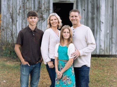 a group of people posing for a photo in front of a building