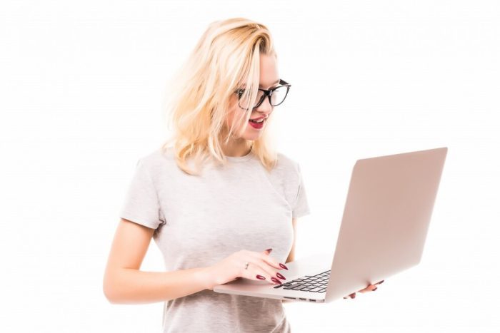 blonde-journalist-glasses-holds-her-laptop-her-hands_231208-2398