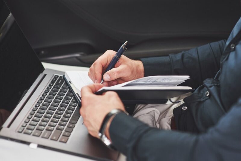 business-hand-writing-notes-car-seat-preparing-meeting_146671-18651