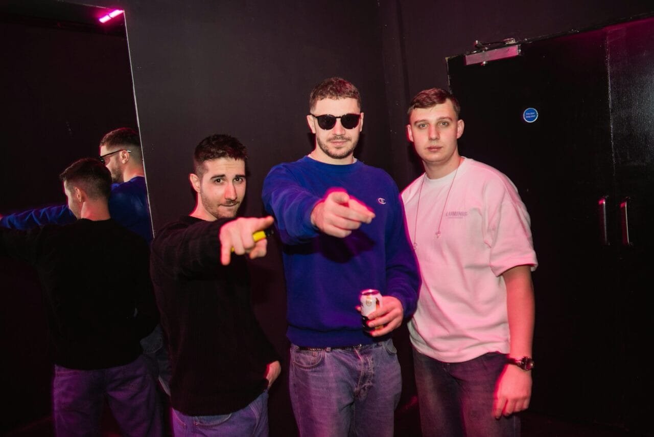 A group of young men standing next to each other