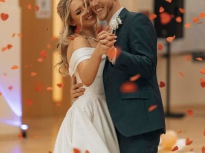A bride and groom are posing for a picture