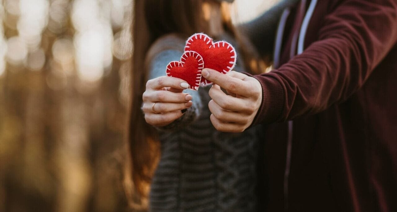 Close Up Couple Holding Little Hearts 23
