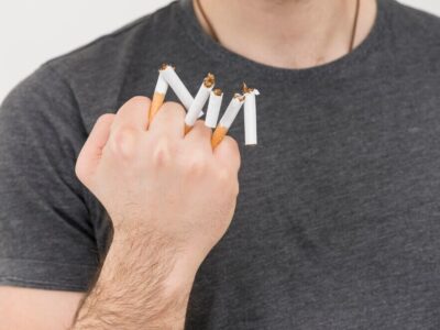 close-up-man-s-hand-showing-broken-cigarette-hand_23-2148043755