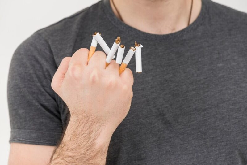 close-up-man-s-hand-showing-broken-cigarette-hand_23-2148043755