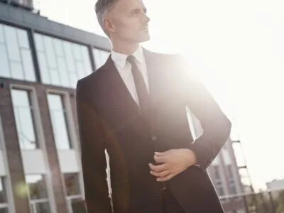confident-mature-businessman-walking-near-office-building-outdoors