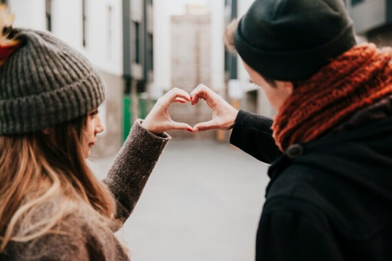 couple-making-hand-heart-gesture_23-2147736116