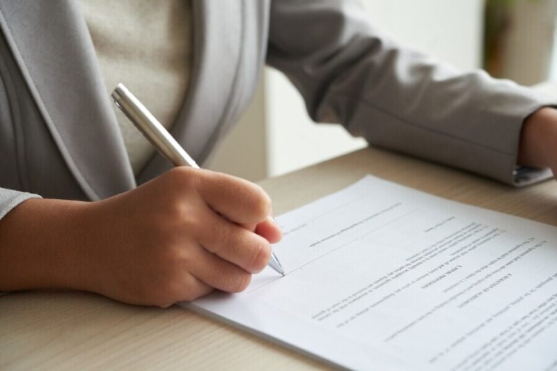 cropped-anonymous-business-woman-checking-agreement-before-signing_1098-18907