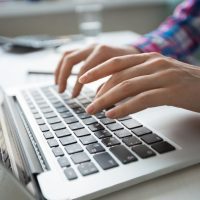 cropped-view-hands-typing-laptop_1262-3196