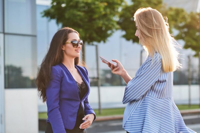 curious-journalist-is-taking-interview-from-successful-businesswoman-street_613910-14047