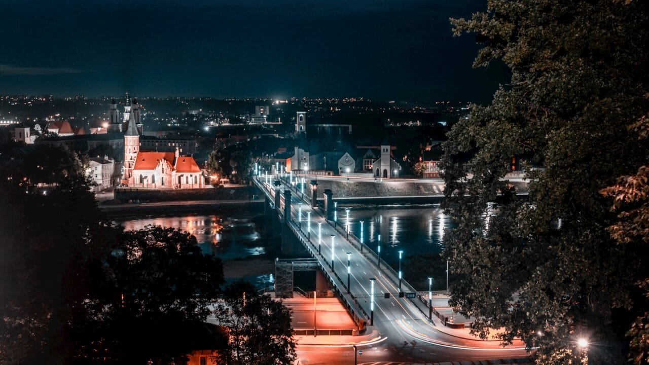 a view of a city at night from a hill