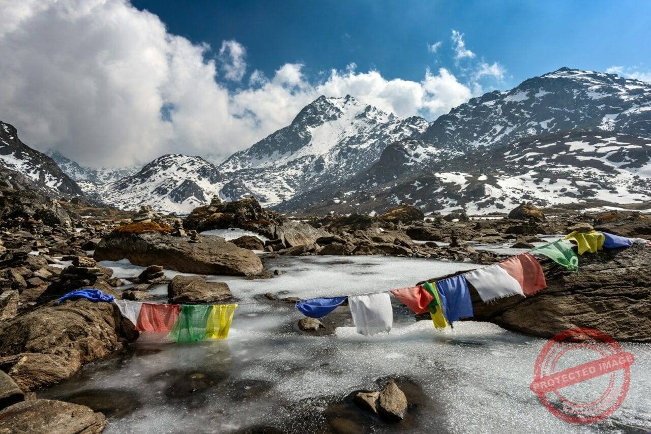 assorted-color of apparel hanged below creek across glacier mountain