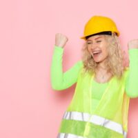 female-builder-green-construction-suit-helmet