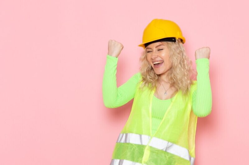 female-builder-green-construction-suit-helmet