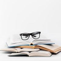 front-view-open-books-with-glasses_23-2148255840