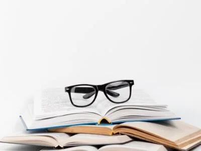 front-view-open-books-with-glasses_23-2148255840