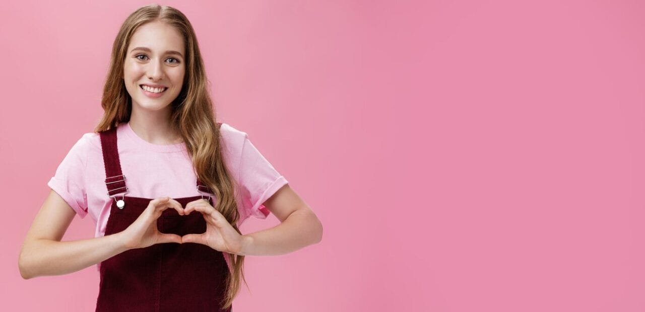 Girl Loves Family Kind Charming Young Woman Overalls With Small Tattoo Arm Showing Heart Gestu
