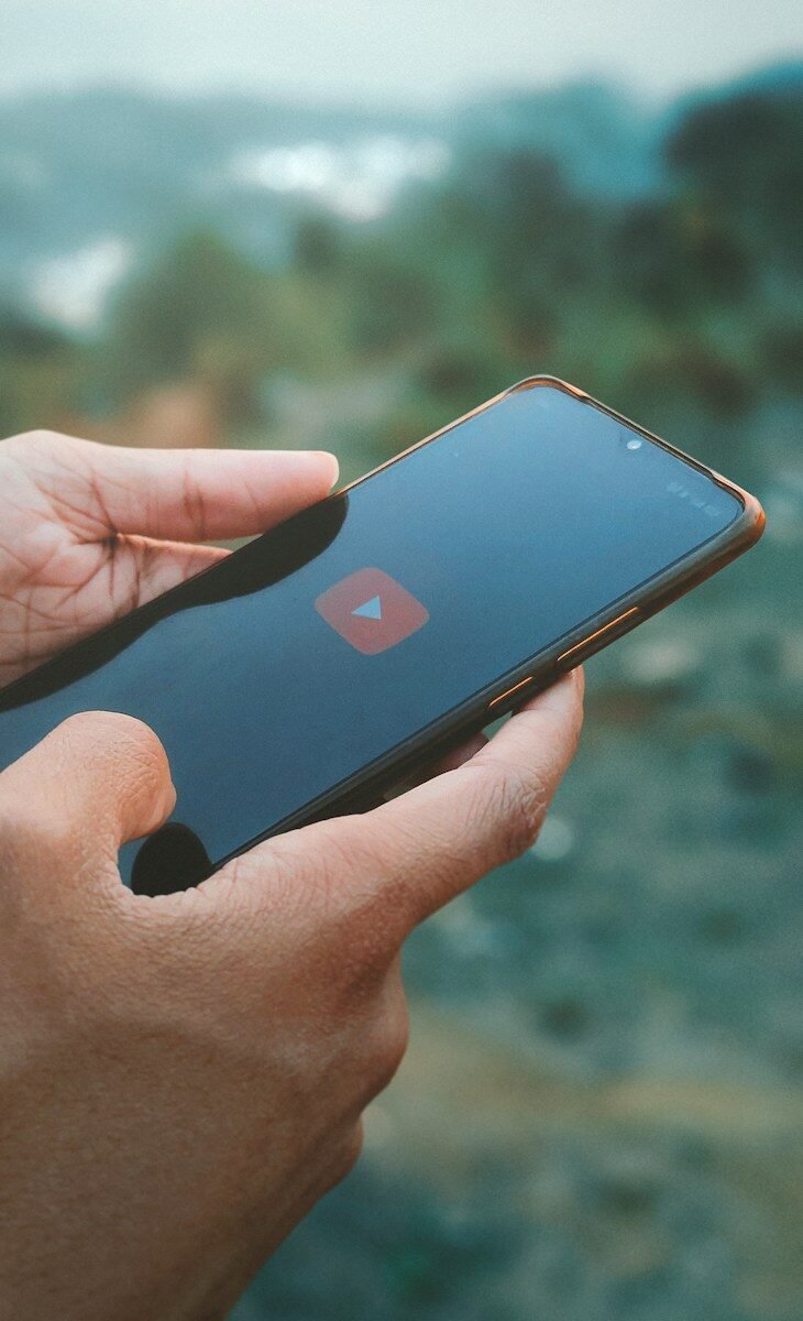 a person holding a smart phone in their hand
