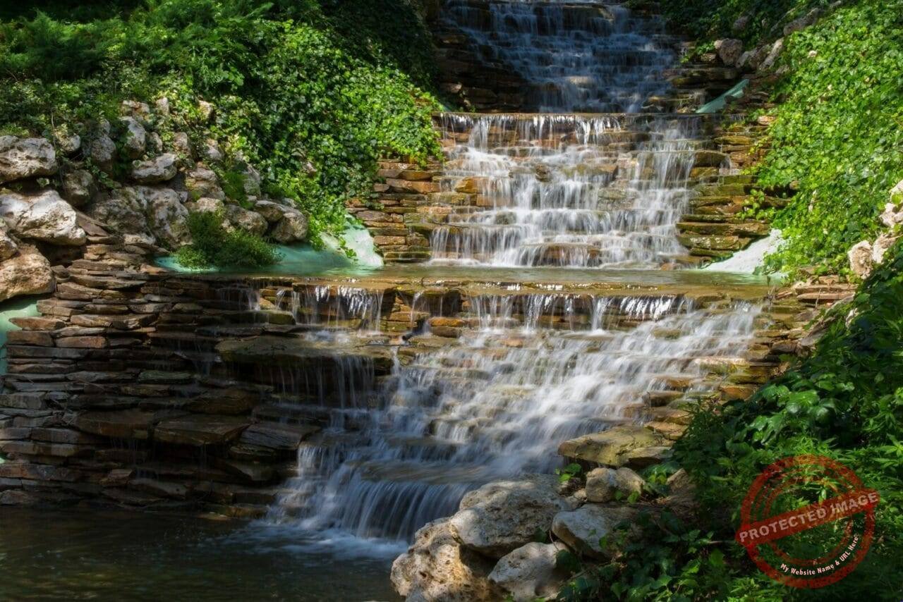a small waterfall in the middle of a forest