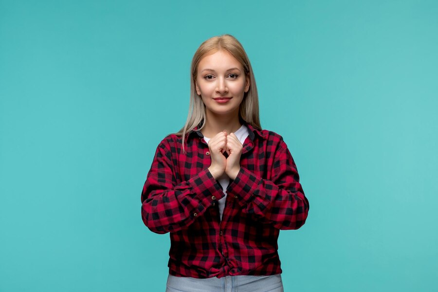 international students day young cute girl red checked shirt holding hands together Straipsniai.lt