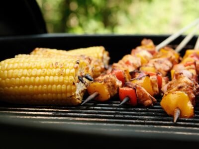corn on the cob and meat on the grill