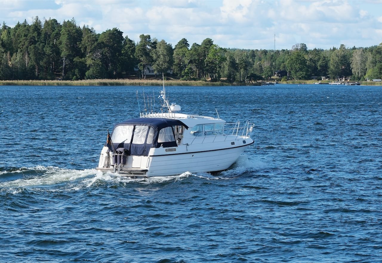 A white boat traveling across a large body of water