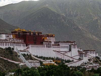white and brown concrete building near mountain during daytime