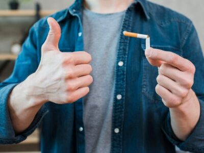 man-holding-broken-cigarette-showing-thumb-up-gesture_23-2148185357