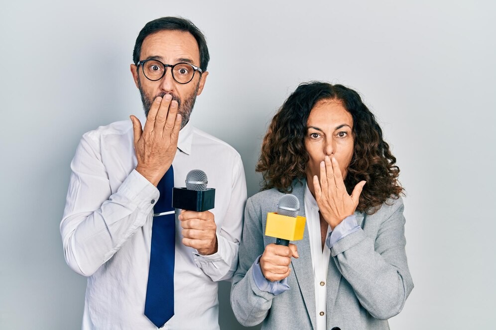 middle-age-couple-hispanic-woman-man-holding-reporter-microphones-covering-mouth-with-hand-shocked-afraid-mistake-surprised-expression_839833-32817