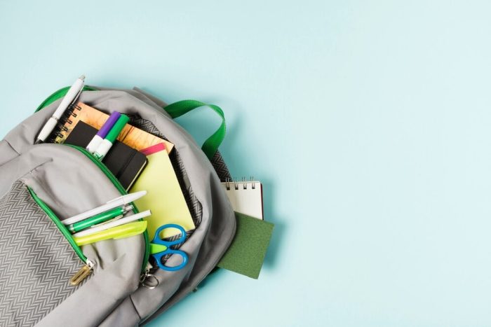 opened-backpack-with-school-supplies_23-2148224209