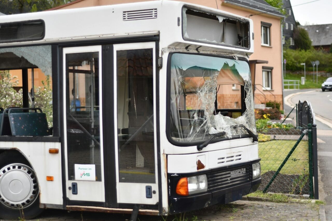 a broken down bus parked on the side of the road