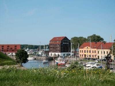 red and white houses near body of water during daytime