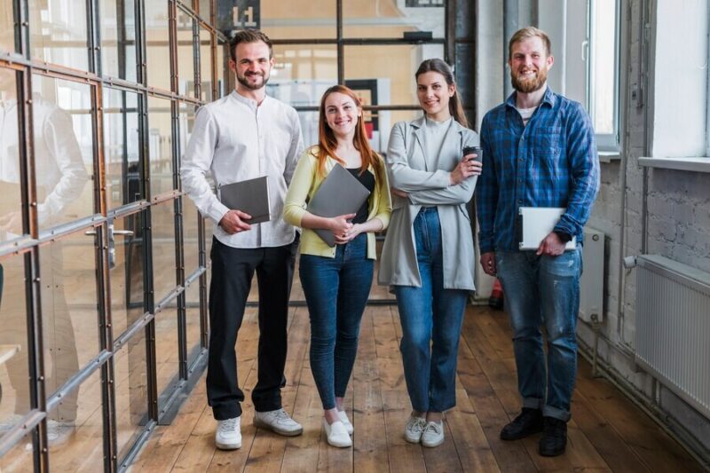 portrait-smiling-businesspeople-standing-office