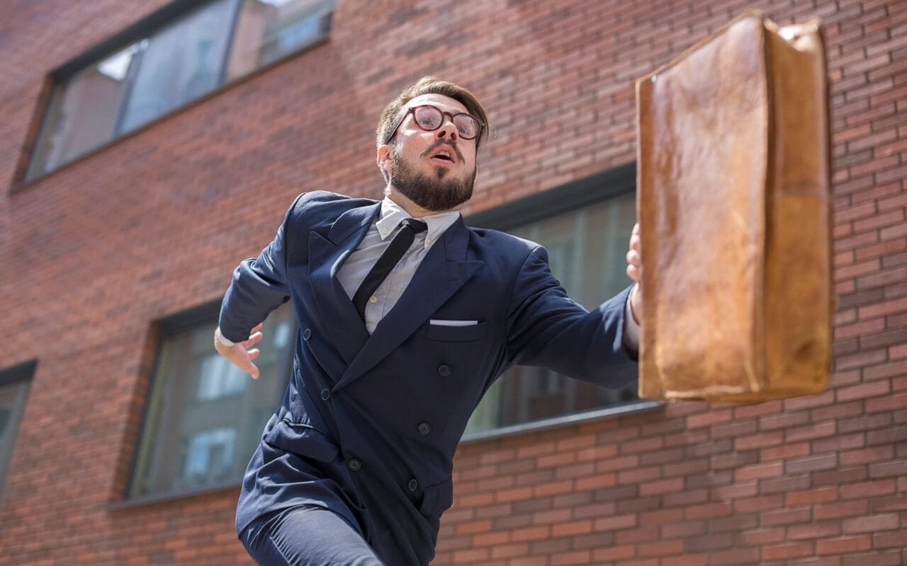 Young businessman running in a city street