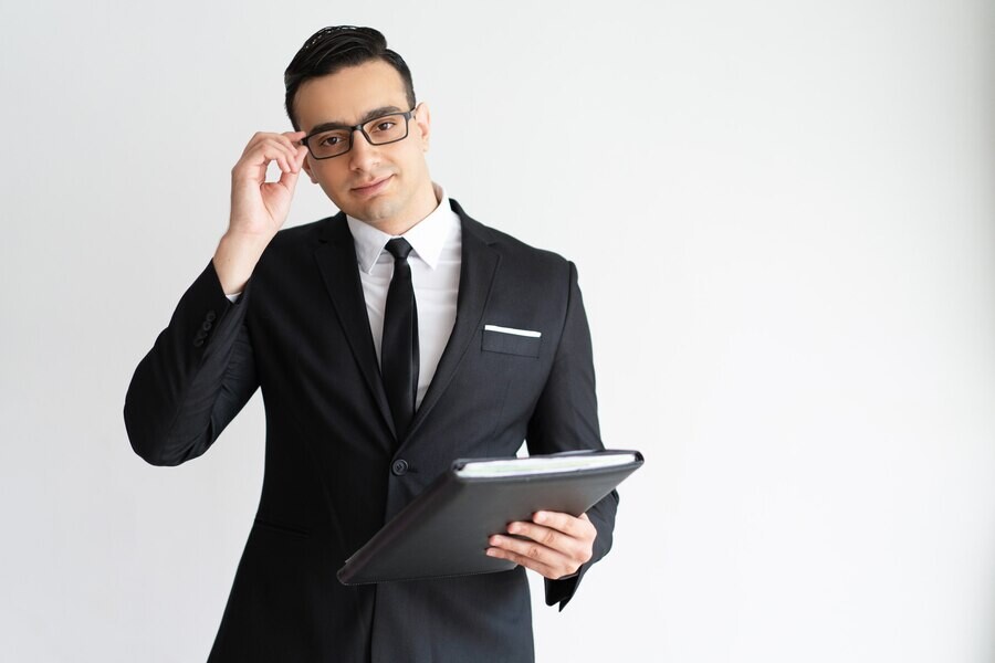 serious-handsome-young-businessman-adjusting-glasses-holding-folder_1262-14365