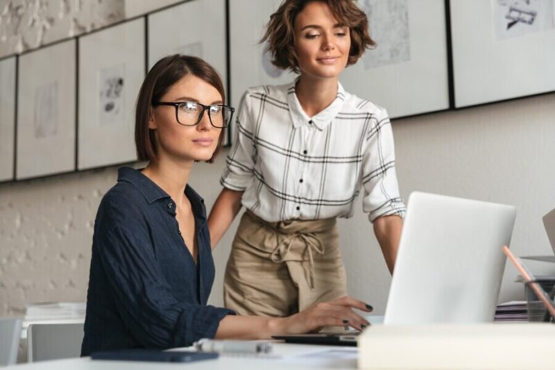 side-view-two-smiling-women-are-discussing-something